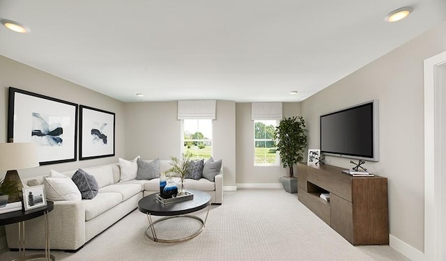 living room featuring recessed lighting, light carpet, and baseboards