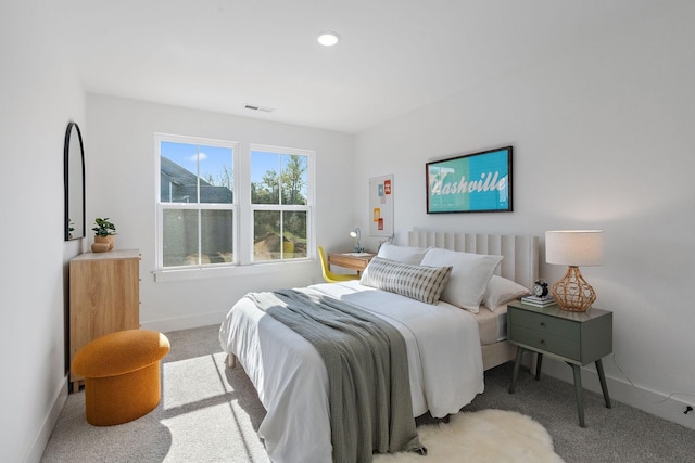 bedroom with light carpet, recessed lighting, visible vents, and baseboards