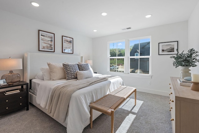 bedroom with recessed lighting, light colored carpet, visible vents, and baseboards