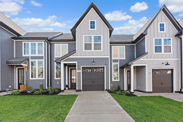 view of front of property with driveway, an attached garage, board and batten siding, and a front yard