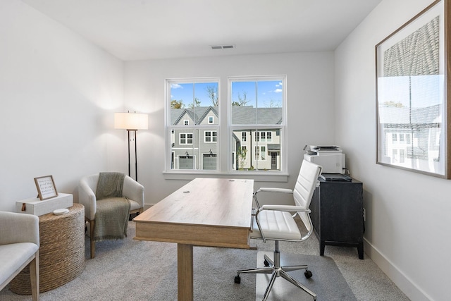 carpeted office space with baseboards and visible vents