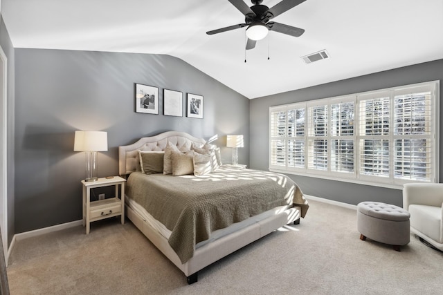 carpeted bedroom featuring baseboards, visible vents, vaulted ceiling, and a ceiling fan