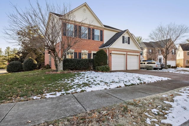 view of front of home featuring driveway and brick siding