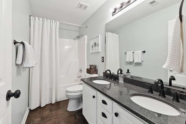 bathroom featuring wood finished floors, a sink, and visible vents