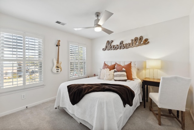 carpeted bedroom featuring baseboards, visible vents, and ceiling fan