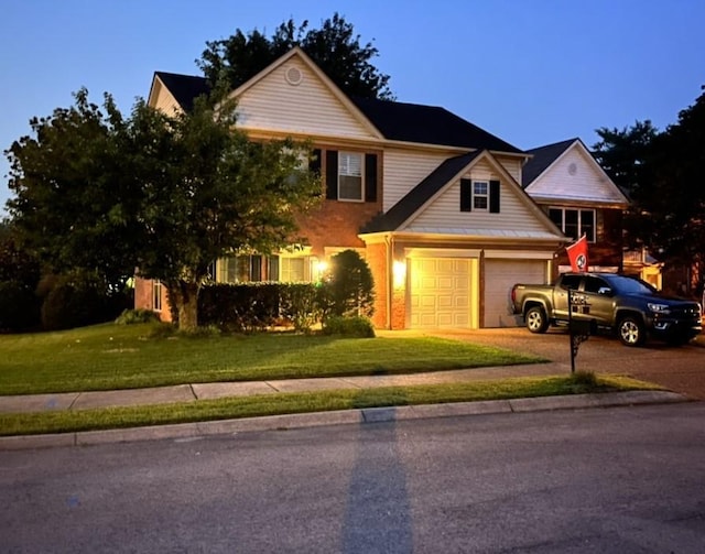 traditional-style house featuring driveway and a front lawn