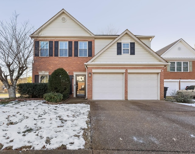 view of front facade featuring driveway and brick siding