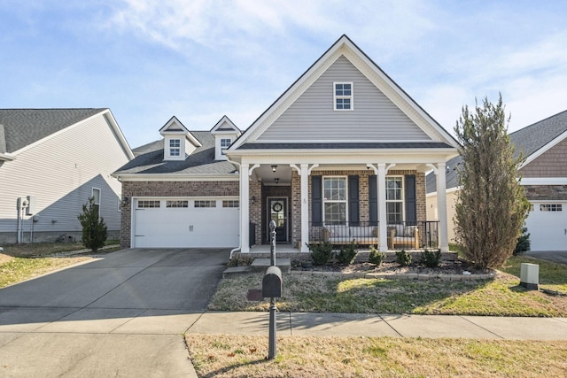 view of front of home with covered porch, driveway, brick siding, and an attached garage