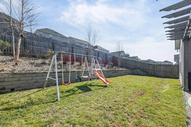 view of yard with a fenced backyard and a playground