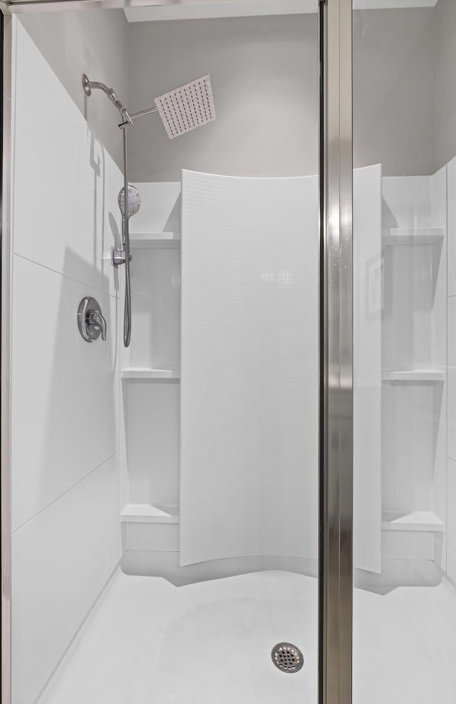 full bath featuring a shower stall