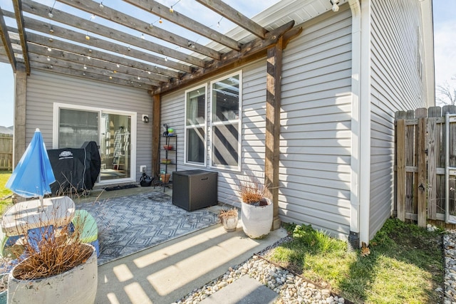 view of patio / terrace featuring fence and a pergola