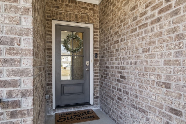 property entrance with brick siding