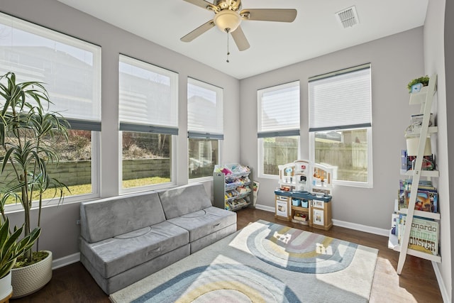 sunroom / solarium featuring ceiling fan and visible vents