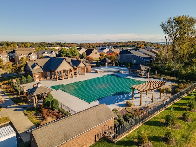 community pool featuring a residential view, a patio area, fence, and a gazebo