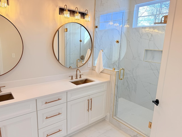 bathroom featuring marble finish floor, a sink, a marble finish shower, and double vanity