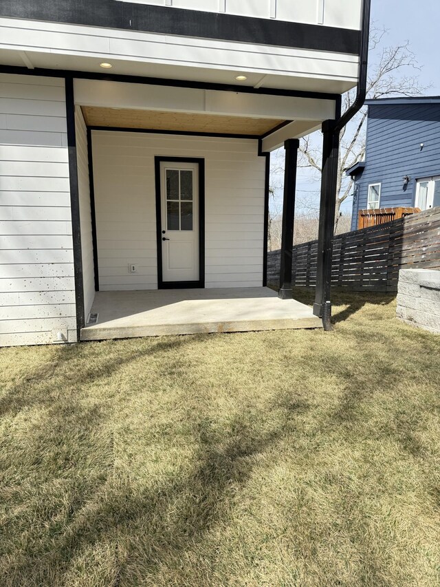 exterior space featuring fence and a lawn