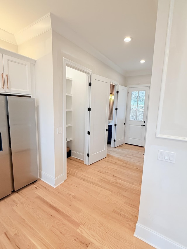 interior space with recessed lighting, white cabinetry, baseboards, light wood-style floors, and stainless steel refrigerator with ice dispenser