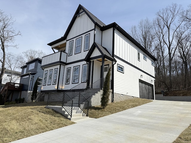 view of front facade featuring concrete driveway, a balcony, an attached garage, stairs, and board and batten siding