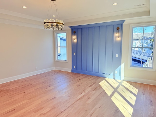 unfurnished room with a chandelier, light wood-style flooring, recessed lighting, baseboards, and crown molding