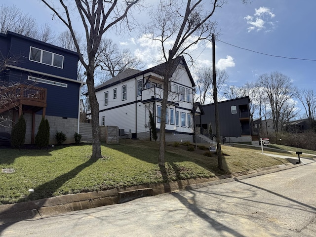 view of side of home with a yard