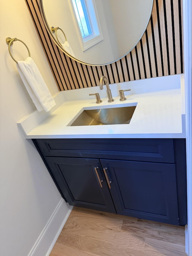 bathroom with wood finished floors and vanity