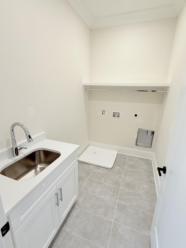 laundry room with light tile patterned floors, hookup for a washing machine, cabinet space, a sink, and electric dryer hookup