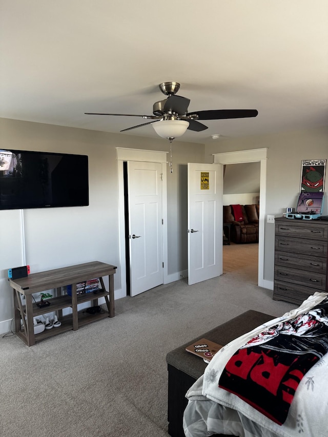 carpeted bedroom featuring ceiling fan and baseboards