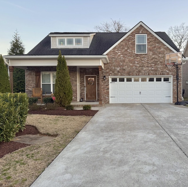 view of front facade with driveway, covered porch, an attached garage, and brick siding