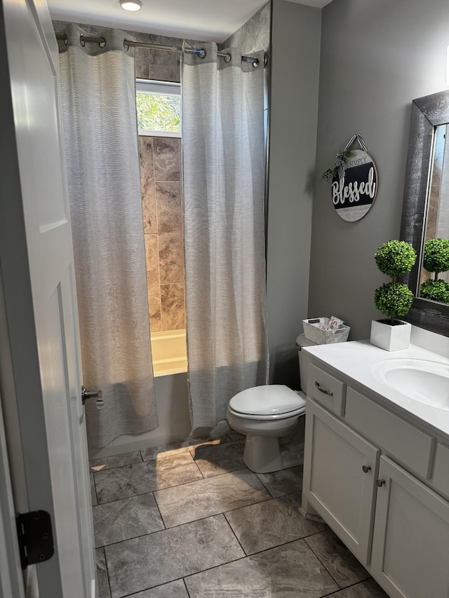 bathroom with vanity, shower / bath combination with curtain, and toilet