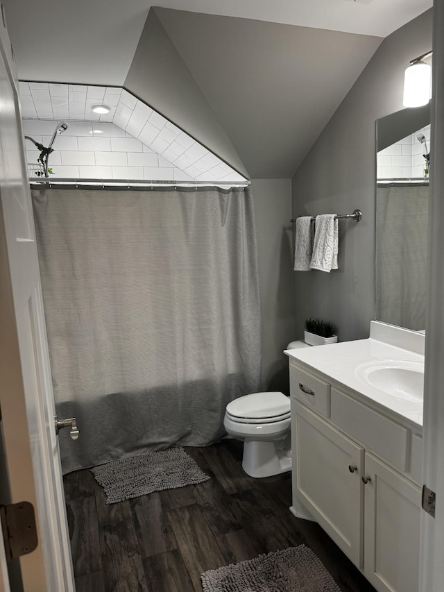 full bathroom with toilet, wood finished floors, vaulted ceiling, shower / bath combination with curtain, and vanity