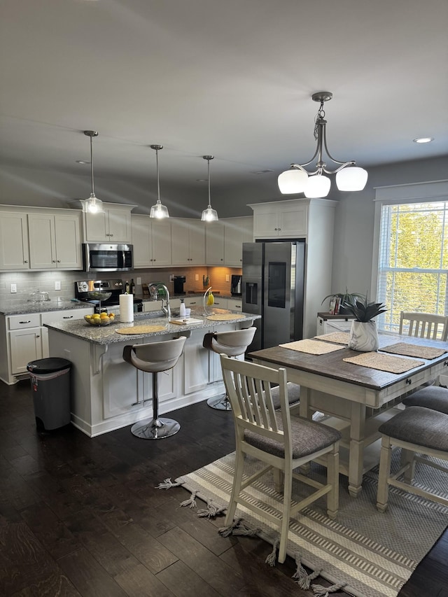 dining area featuring dark wood-style flooring