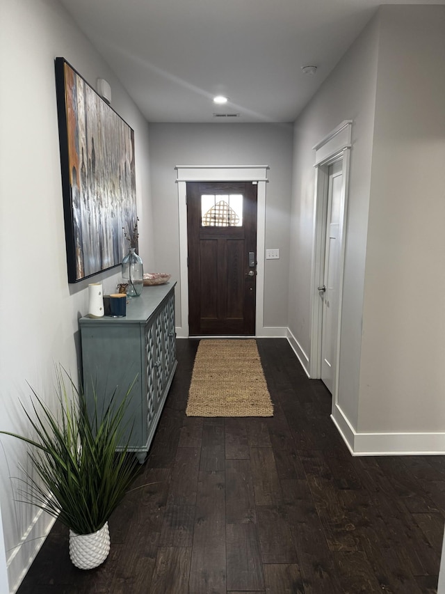 foyer featuring recessed lighting, dark wood finished floors, visible vents, and baseboards