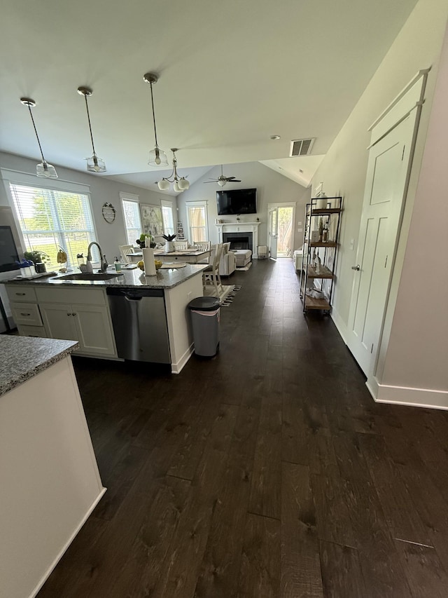 kitchen with a sink, dark wood-style flooring, visible vents, dishwasher, and open floor plan