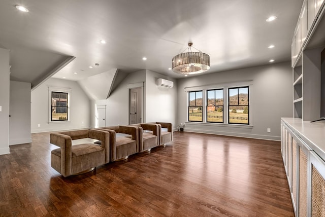 home theater with dark wood-style floors, a wall unit AC, baseboards, and recessed lighting