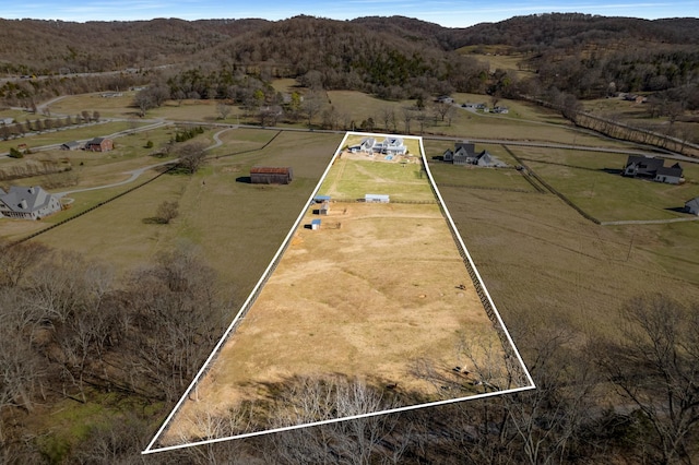 birds eye view of property with a rural view and a mountain view