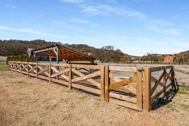 view of gate featuring an outbuilding