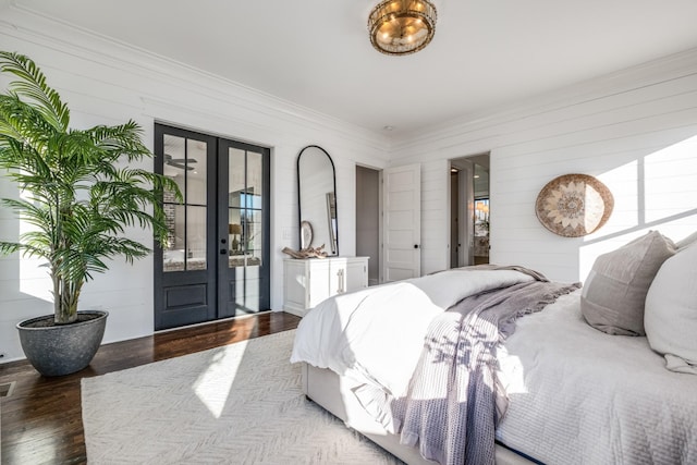 bedroom featuring french doors, wood finished floors, and crown molding