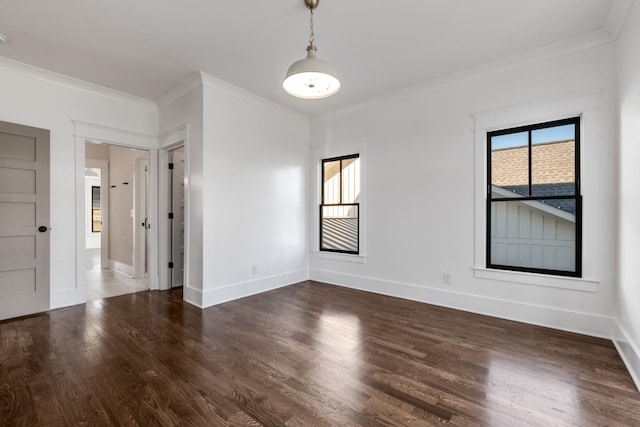 unfurnished room featuring a healthy amount of sunlight, baseboards, dark wood-type flooring, and crown molding