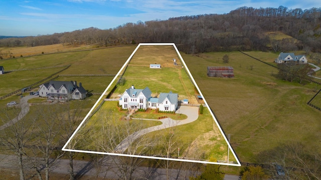 aerial view with a rural view and a wooded view