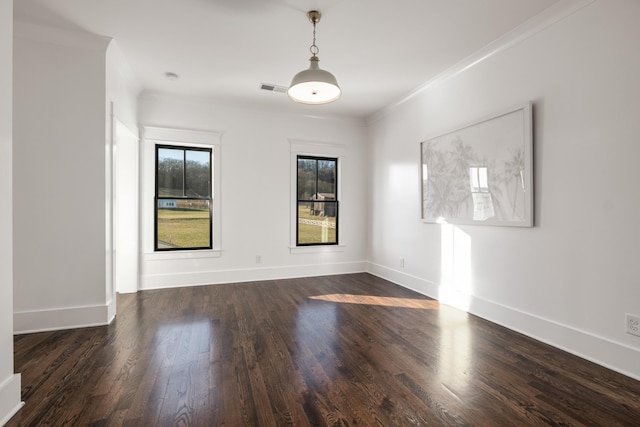 unfurnished room with ornamental molding, visible vents, dark wood finished floors, and baseboards