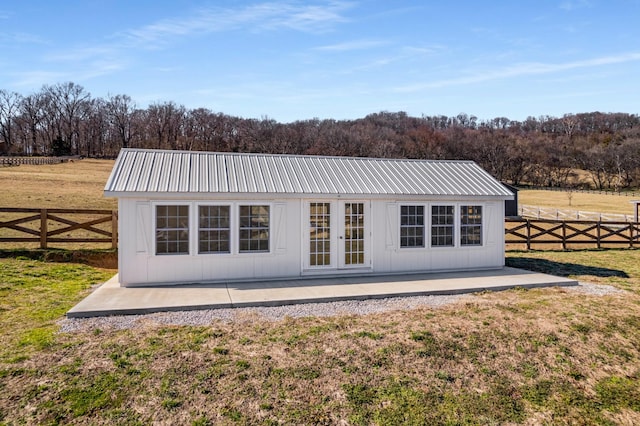 back of property featuring metal roof, a patio, fence, a yard, and french doors