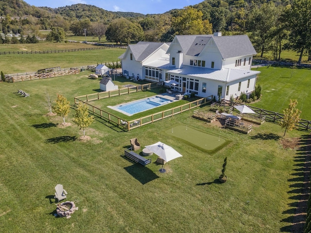 birds eye view of property with a rural view