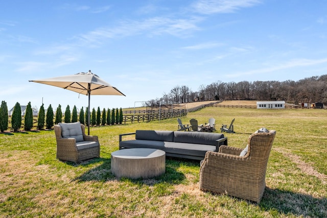 view of yard with a rural view and an outdoor living space