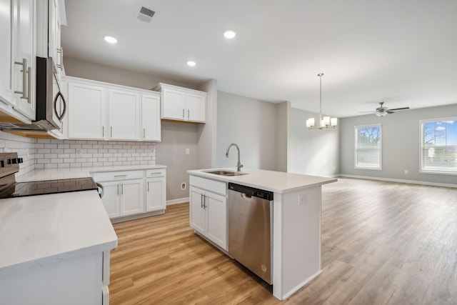 kitchen with decorative backsplash, stainless steel appliances, light wood-type flooring, white cabinetry, and a sink