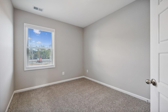 unfurnished room with visible vents, baseboards, and carpet flooring