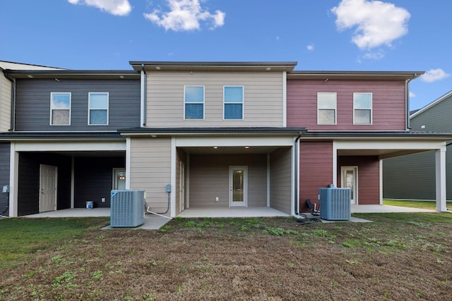 rear view of property featuring a patio area, a yard, and central AC unit