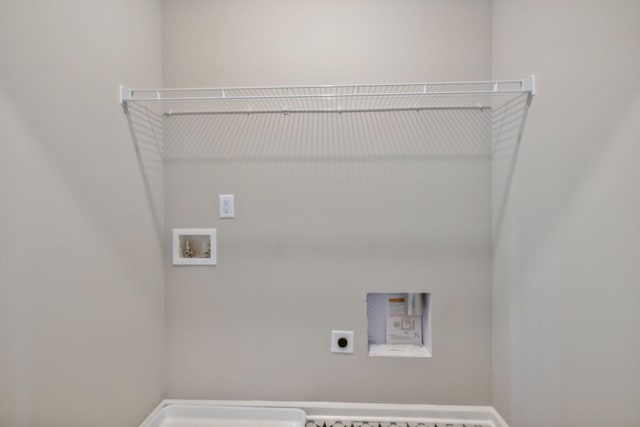 laundry room featuring laundry area, hookup for a washing machine, baseboards, and hookup for an electric dryer