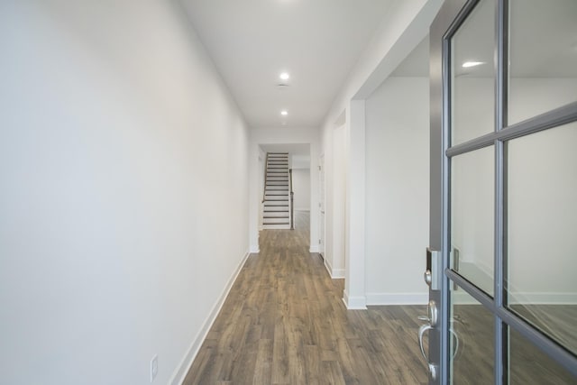 hall featuring stairs, dark wood-style flooring, recessed lighting, and baseboards