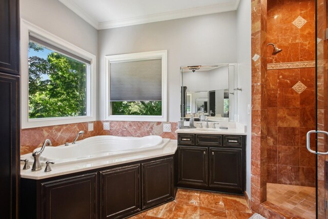 bathroom with a bath, plenty of natural light, a shower stall, and crown molding