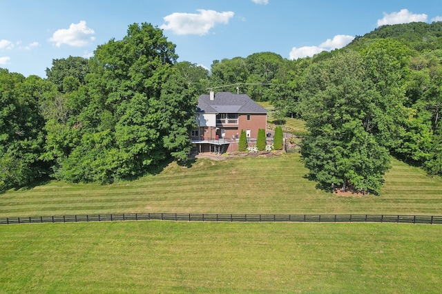 drone / aerial view featuring a rural view and a view of trees